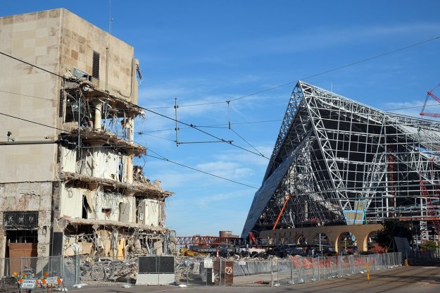 the kaiju is devouring the older buildings in Minneapolis