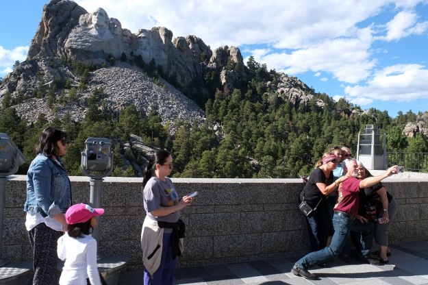 Notice the extreme stretch required to take a selfie which includes a crowd. This man needs a selfie stick.