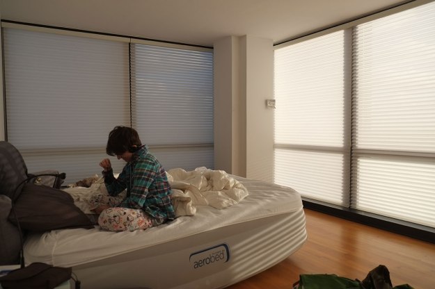 Staying in a corner room in a Mies apartment building on Lake Shore Drive, the teenager will pull all the blinds so she can look at an iPad.